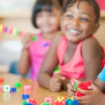 Preschool children learning in school with gadgets.