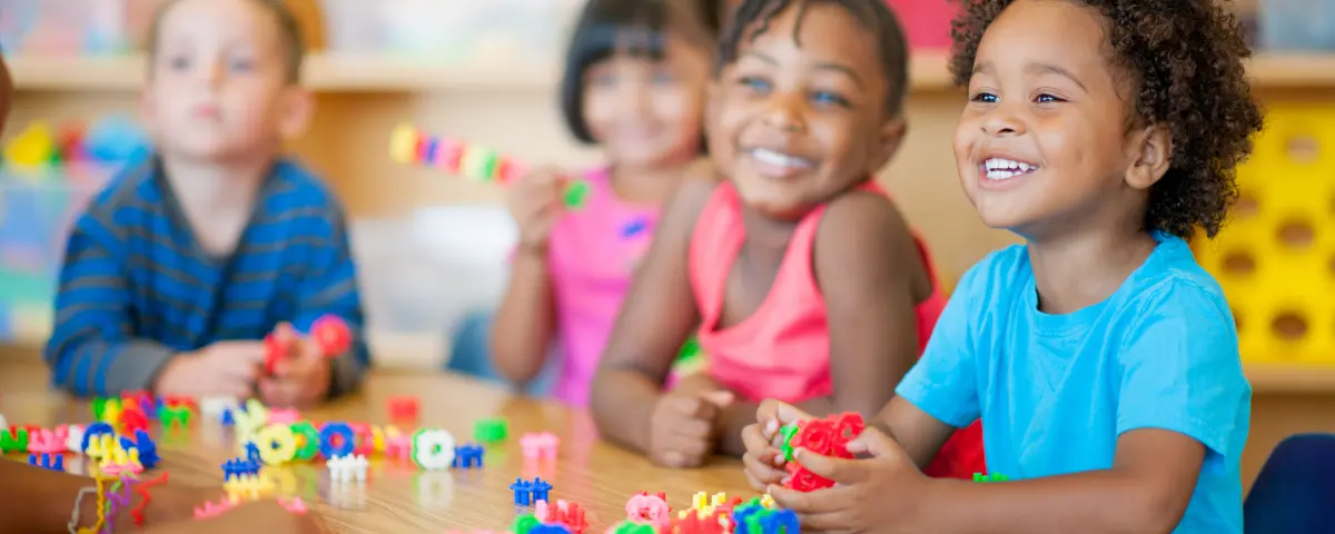 Preschool children learning in school with gadgets.