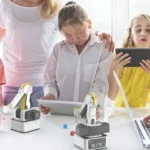 Students learning how to code Dobot robots.