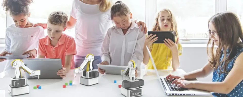 Students learning how to code Dobot robots.