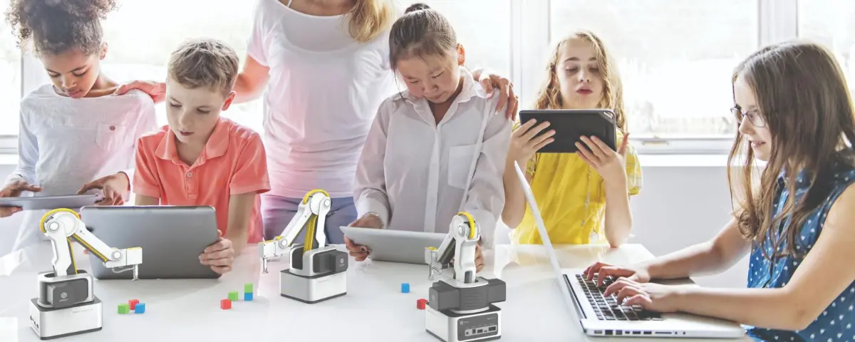 Students learning how to code Dobot robots.