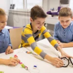 Three students at a table take part in project-based learning at school.
