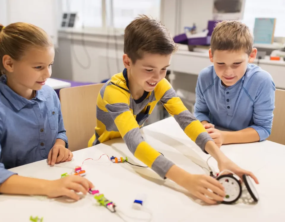Three students at a table take part in project-based learning at school.
