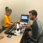 A young girl tinkers at a robotics summer camp