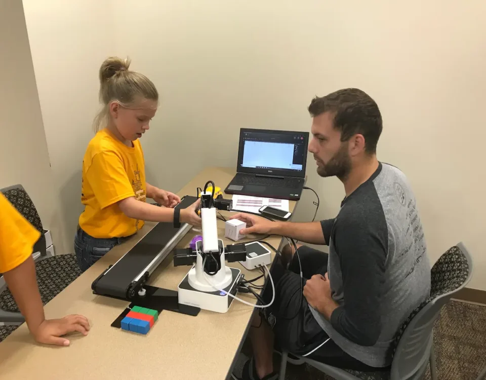 A young girl tinkers at a robotics summer camp