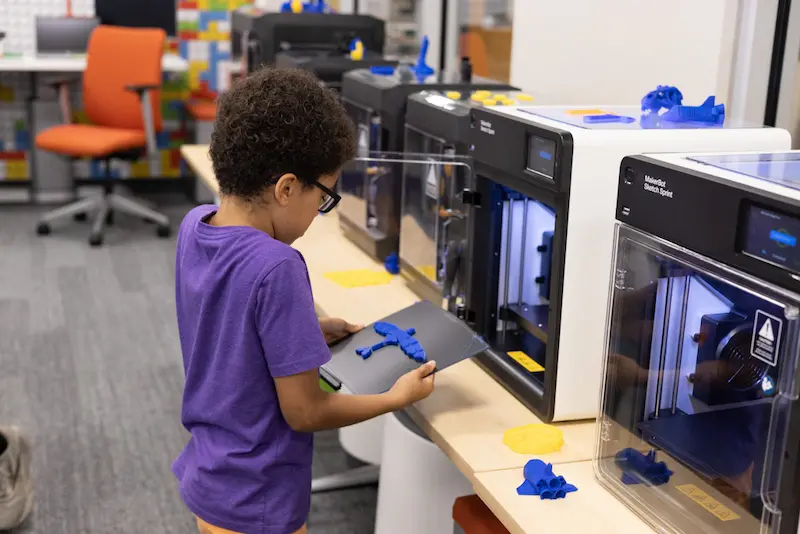 Student learns to use the 3D printer after his school installs a STEM lab
