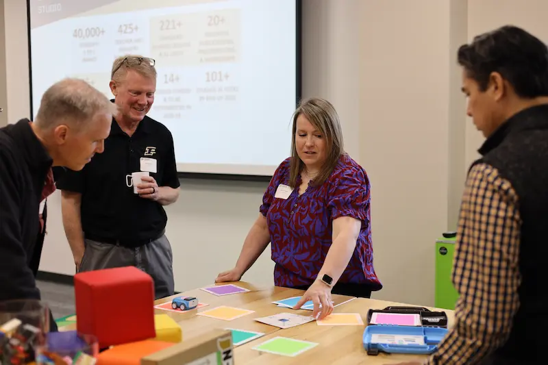 Educator speaks to members of the community after inviting them to the new STEM space
