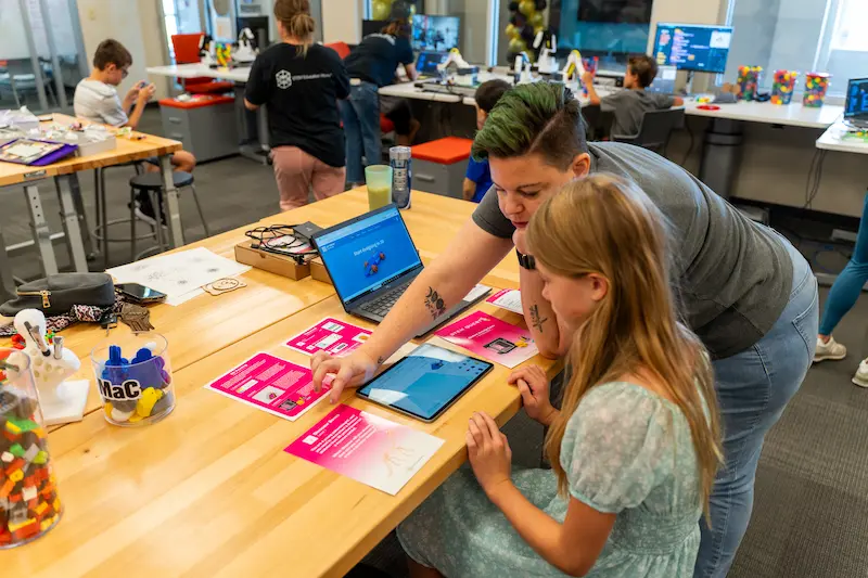 A STEM Education Works specialist helps train and teach at a school’s new STEM space. 