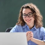 Teacher smiles after being approved for a grant.