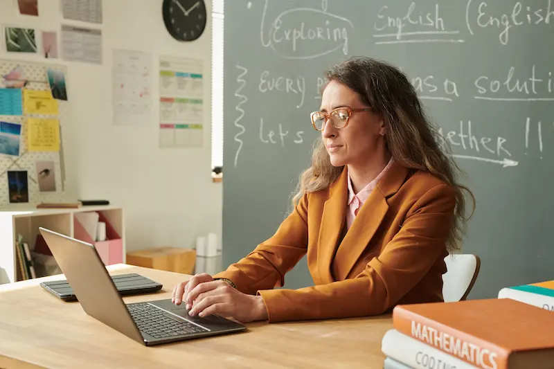 A teacher uses laptop to search for STEM education grants 