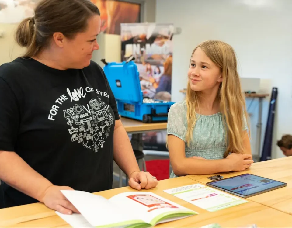Our instructor, Sarah, helps a young techie learn coding.