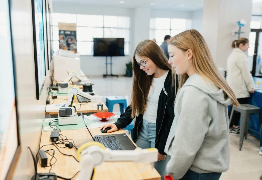Two students working on a laptop in an industry lab