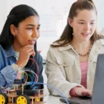 Two teenagers using AI in the classroom.