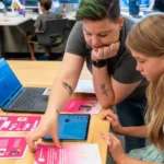Chauntée helping a student understand STEM Quest Activity Cards in a STEM Lab.