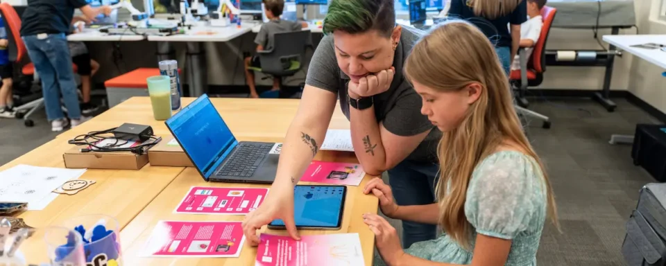 Chauntée helping a student understand STEM Quest Activity Cards in a STEM Lab.