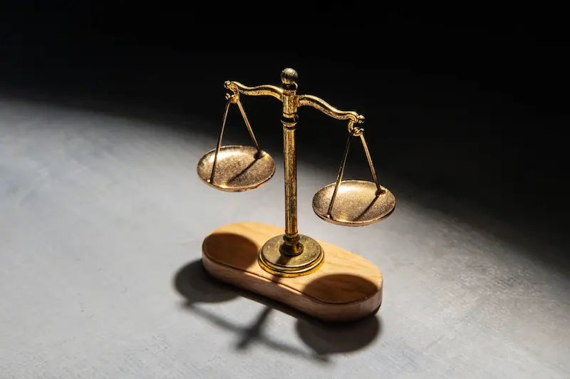 A set of golden scales used to compare the weight of two objects.