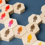 A network of wooden hexagonal blocks with illustrations of people on them.