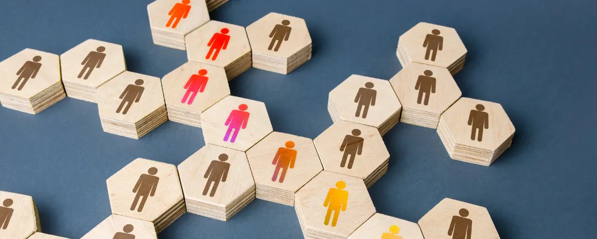 A network of wooden hexagonal blocks with illustrations of people on them.