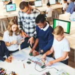 A group of students working on a STEM project on a table in a library.