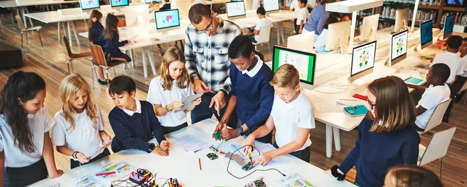 A group of students working on a STEM project on a table in a library.