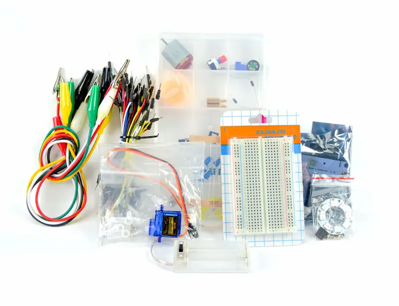 The contents of the micro:bit Starter Kit, including a breadboard, jumper wires, cables, a battery pack, and more.