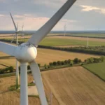 Wind turbines generating electricity in a field.