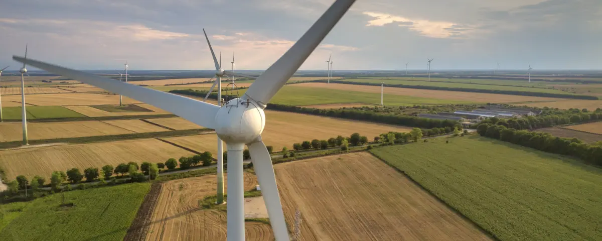 Wind turbines generating electricity in a field.