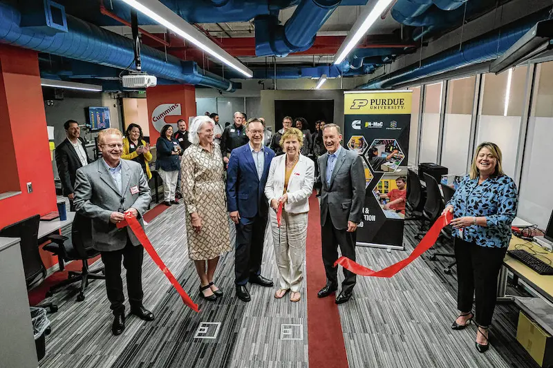 Cummins Inc. employees celebrate the ribbon-cutting ceremony for their Design and Innovation Studio, along with partners Purdue IN-MaC and STEM Education Works.
