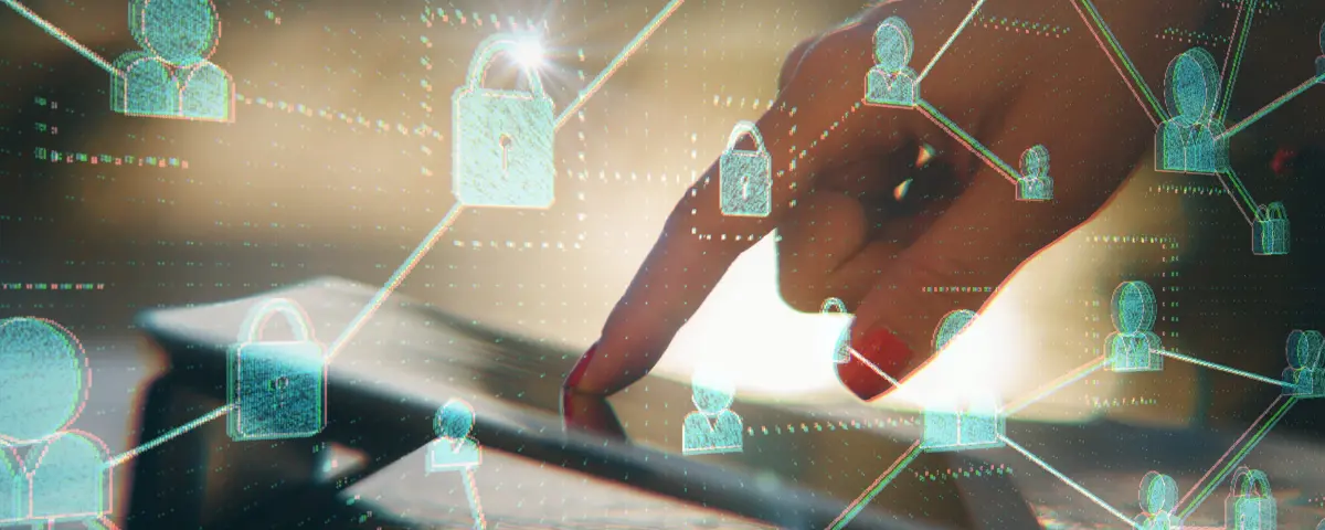 Close-up of a hand pointing at a tablet with people and lock icons connected with lines.