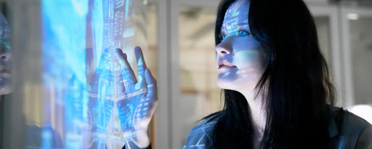 Woman interacting with a blue holographic screen.