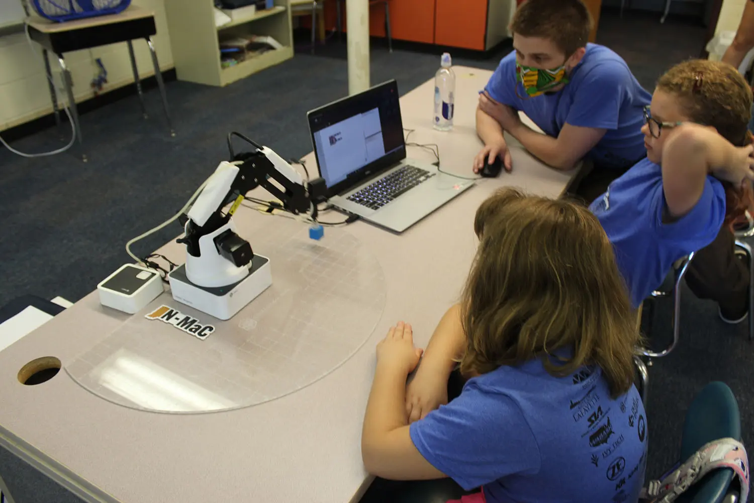 Students work with a mentor on Dobot robotics during the Greater Lafayette Robotics Camp with the Boys and Girls Club of White County.