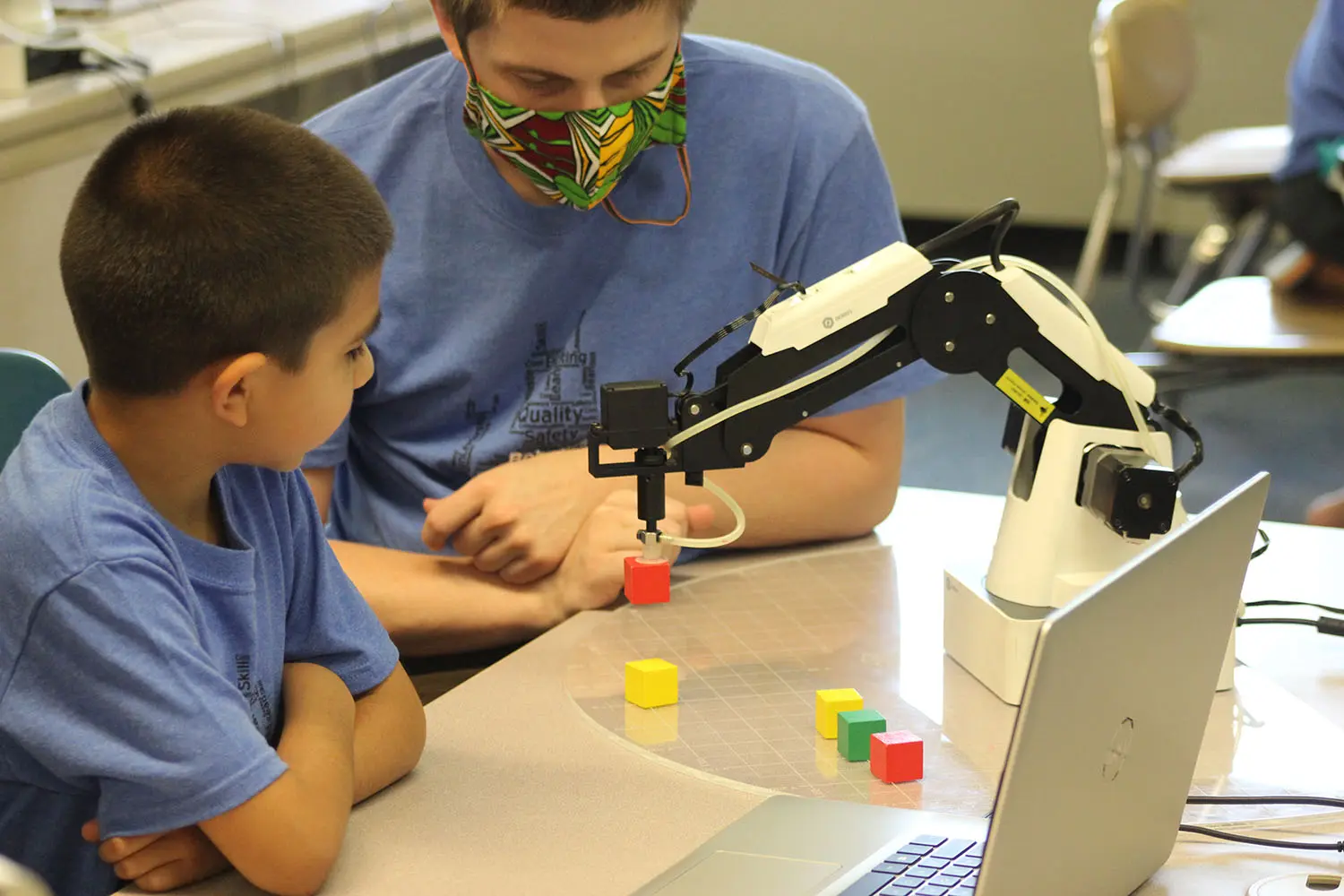 Student works with a mentor at the Boys and Girls Club of White County on Dobot Robotics.