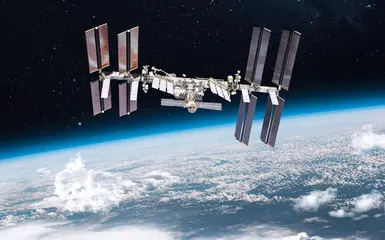 The International Space Station floating in space above Earth.