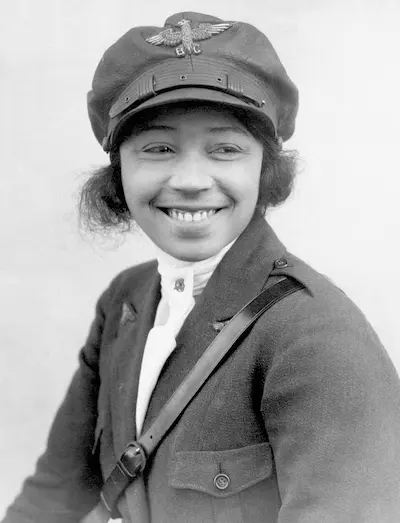 Black and white photograph of Bessie Coleman wearing a cap embellished with a metal eagle.