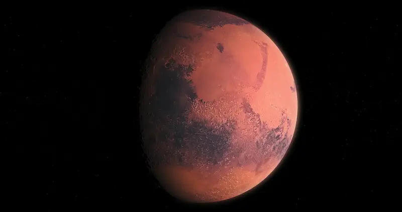 The red planet Mars against the black background of space.