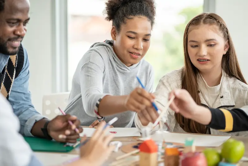 Students painting together during art class.