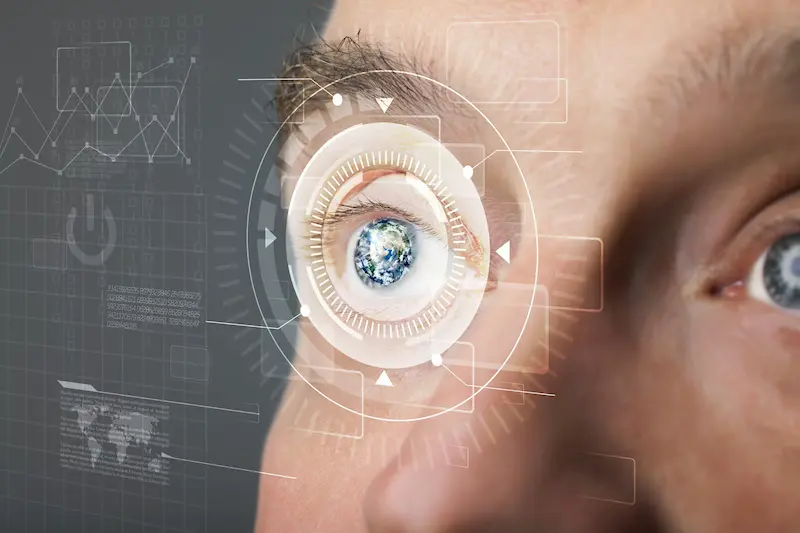 A man's bionic eye surrounded with a digital interface.