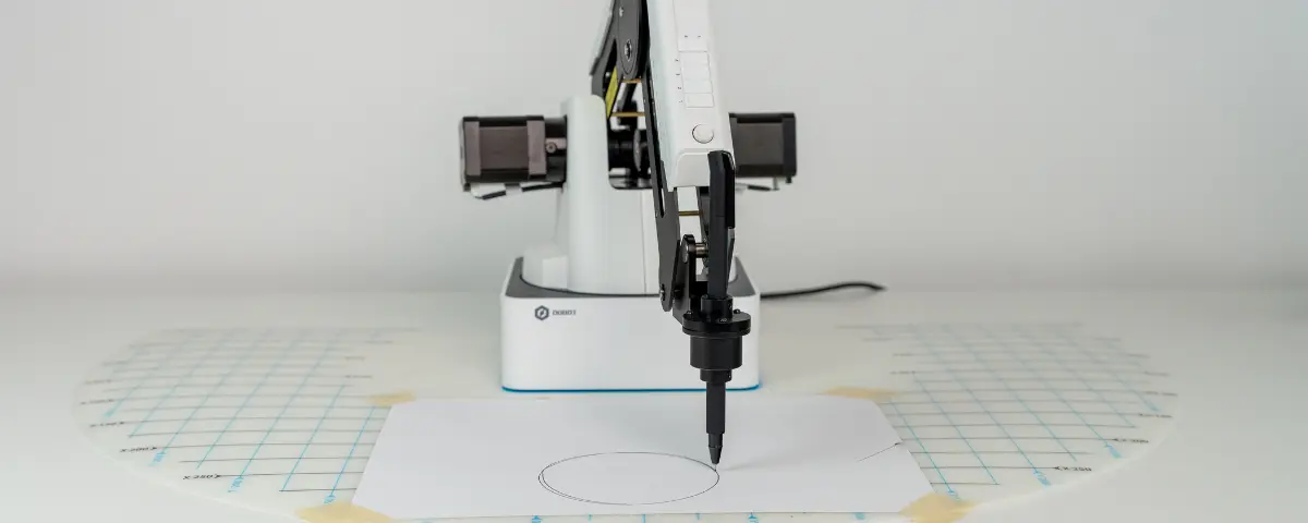 Dobot Magician drawing a circle on a piece of paper using the pen end effector.