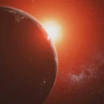 View of Earth from space, illuminated by a red sun in the background