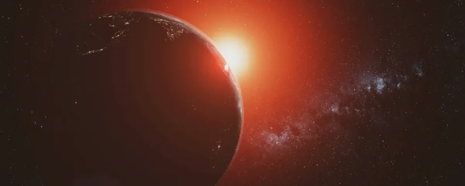 View of Earth from space, illuminated by a red sun in the background
