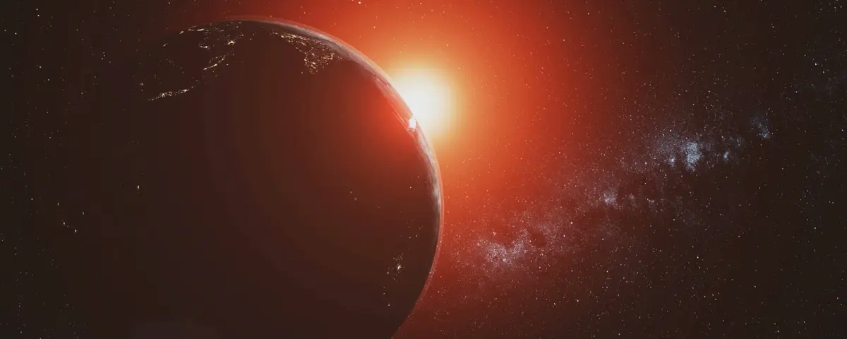 View of Earth from space, illuminated by a red sun in the background